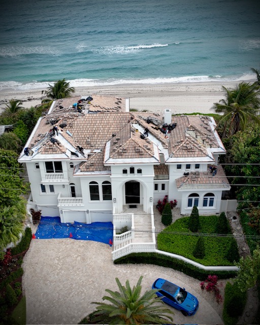Tile roof rebuild in progress on a Palm Beach County home — Mike McGilvary Roofing removing and reinstalling tiles during valley rebuild