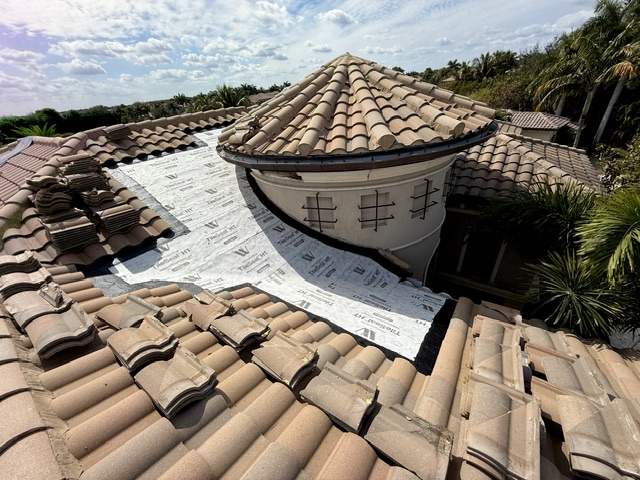 A Palm Beach County tile roof with new synthetic underlayment installed beneath lifted barrel tile by Mike McGilvary Roofing, documenting secondary water resistance