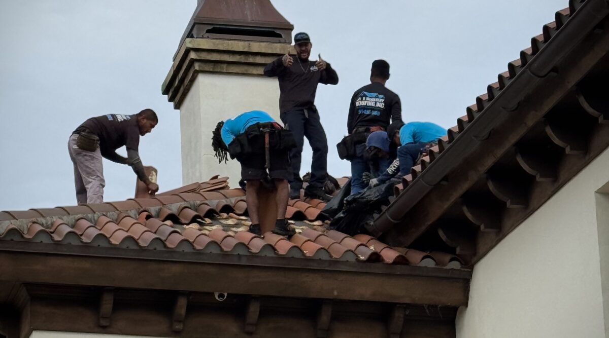 Mike McGilvary Roofing crew repairing a tile roof on a Palm Beach County estate