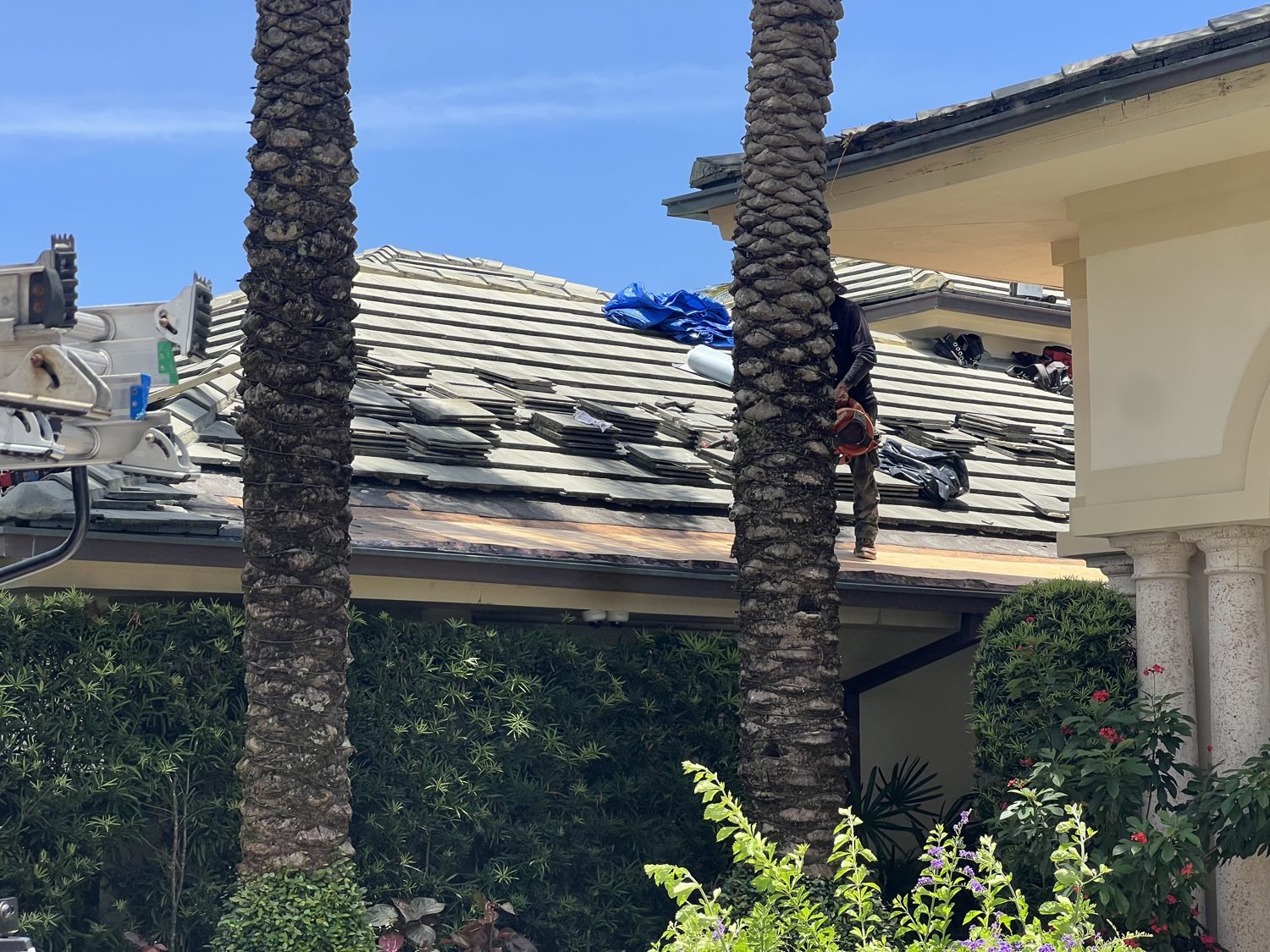 Mike McGilvary Roofing crew opening a failed roof section on the estate