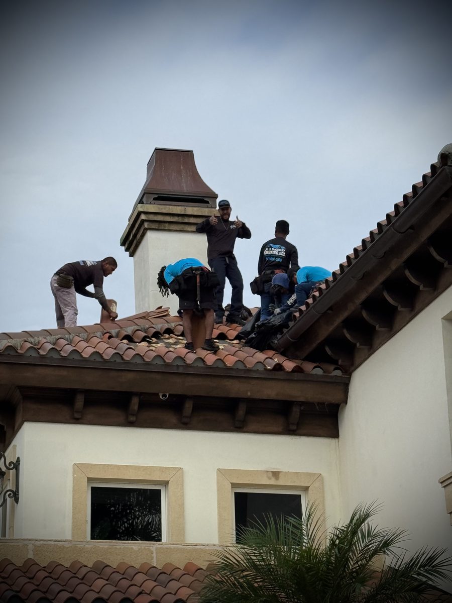 MMR roofer on the ridge of an estate tile roof