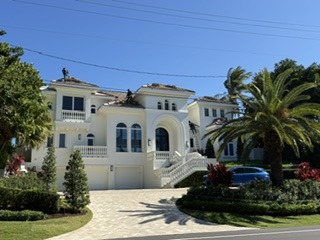 Aerial view of the Highland Beach oceanfront estate and its tile roof