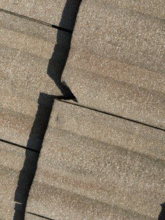 A cracked concrete roof tile documented at Barletta Winds Point, Delray Beach