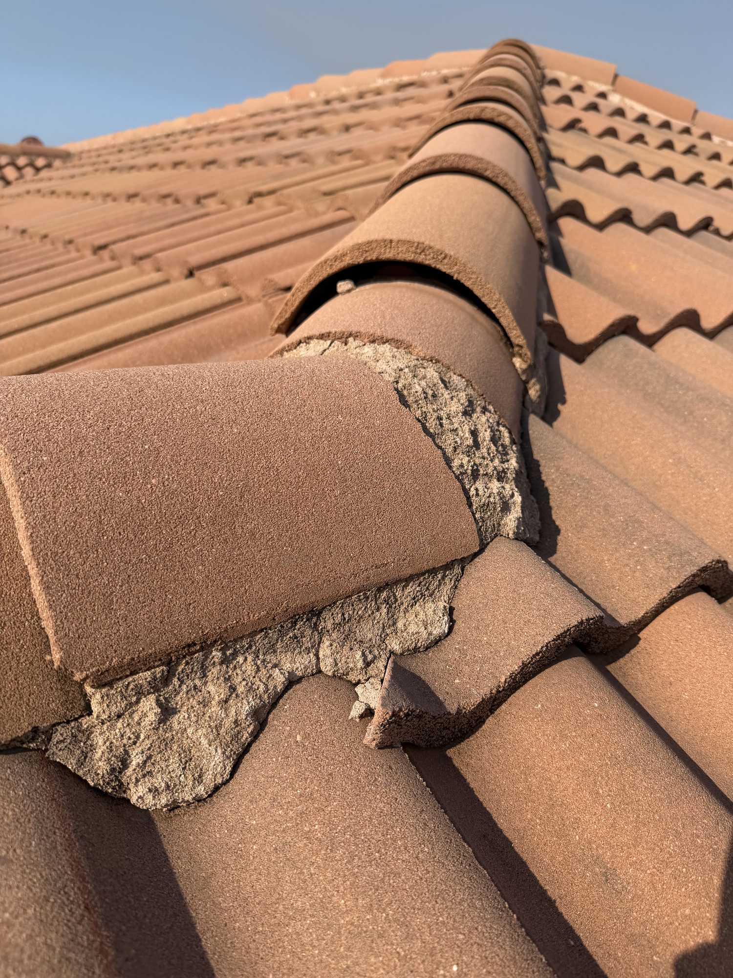 Deteriorated ridge-cap mortar documented on the Barletta Winds Point tile roof, Delray Beach