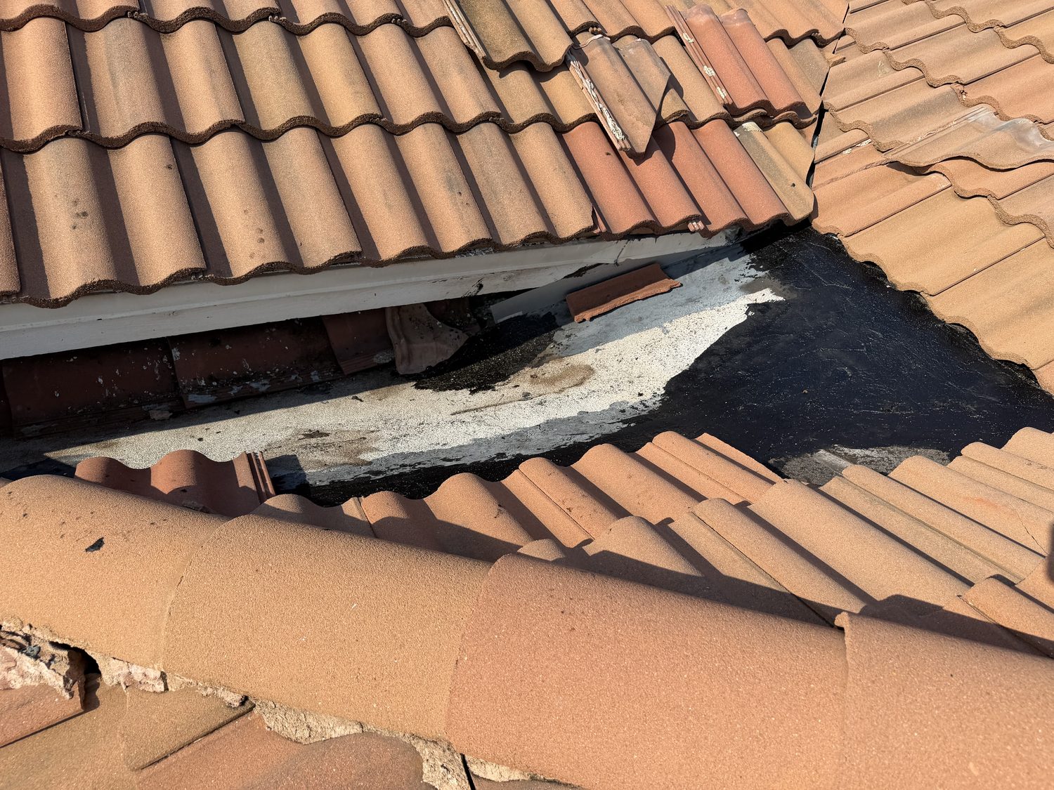 Open tile roof section with exposed decking documented during the Barletta Winds Point inspection, Delray Beach