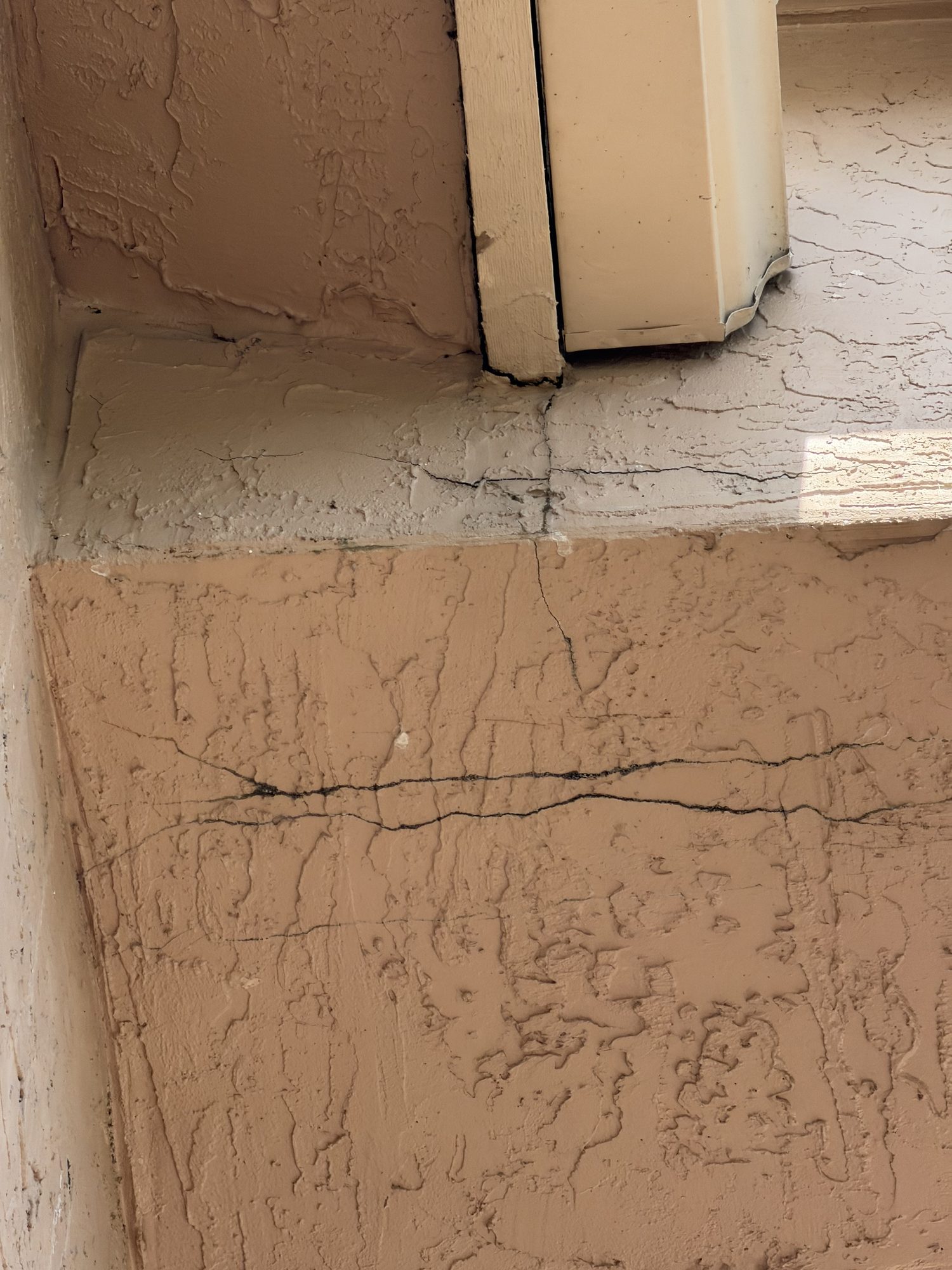 Cracked stucco and fascia showing a water-intrusion path below the roof at Barletta Winds Point, Delray Beach