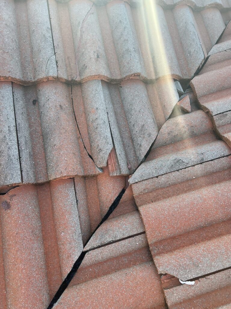 Cracked roof tiles documented on a Delray Beach 33484 tile roof