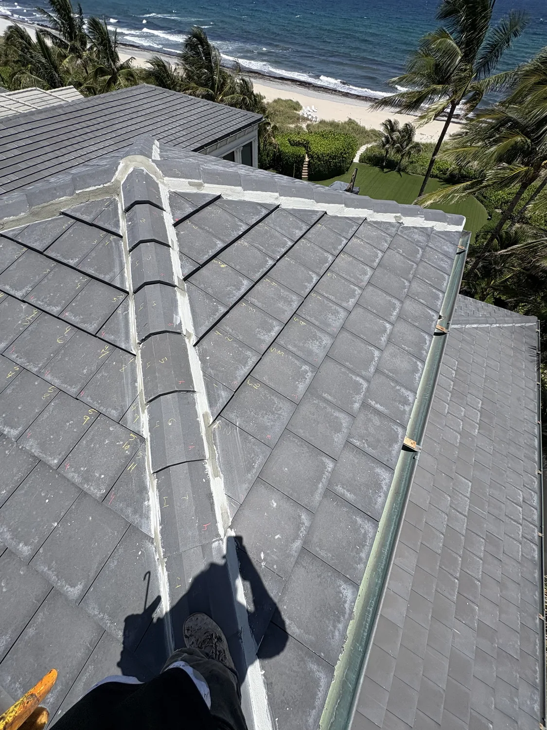 Numbered concrete tiles prepared for accurate roof reinstallation on the Delray Beach oceanfront estate