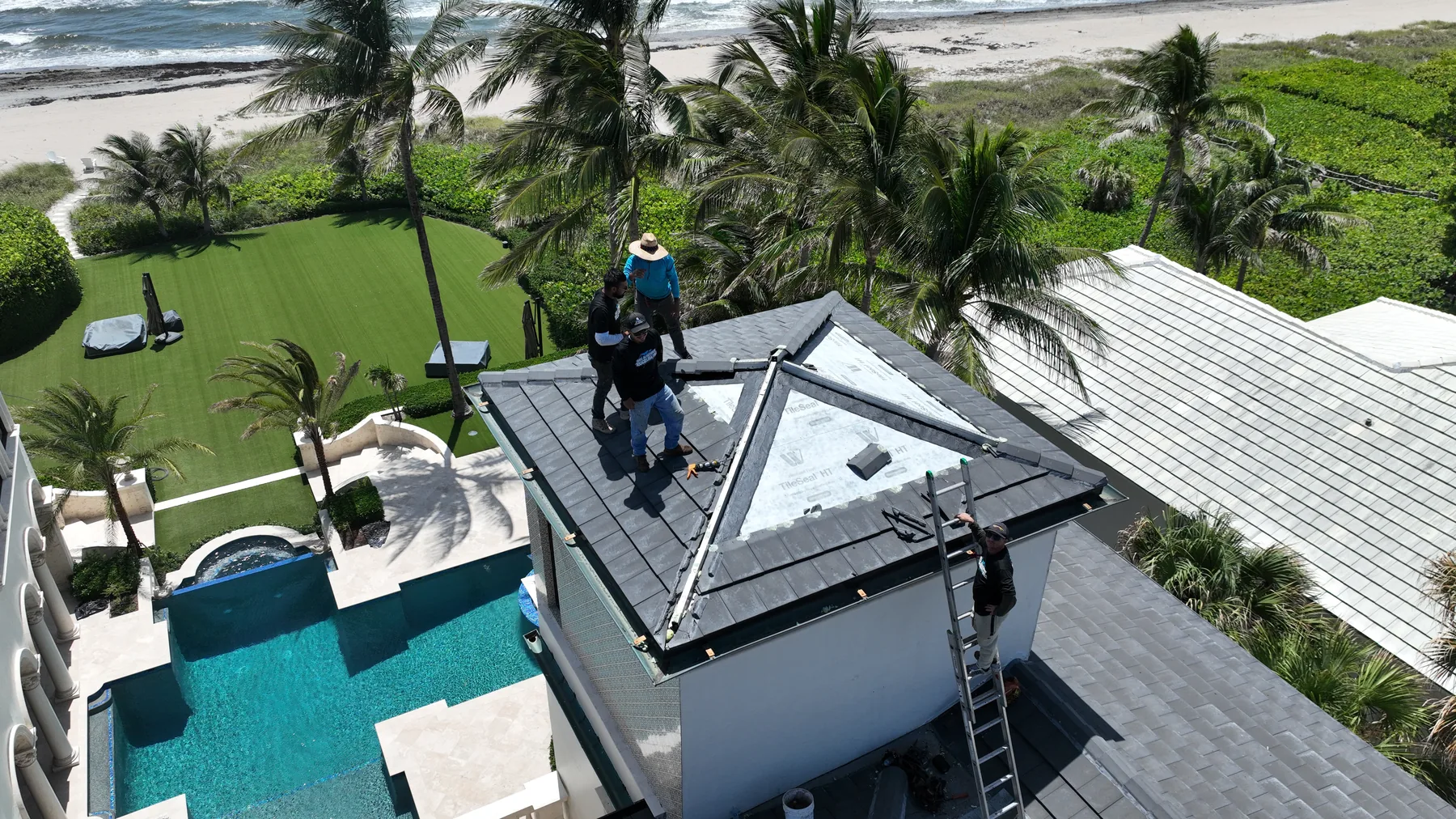 Roofing specialists preserving the tile roof on the South Florida oceanfront estate