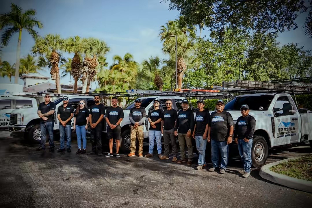 The Mike McGilvary Roofing crew in front of the company fleet