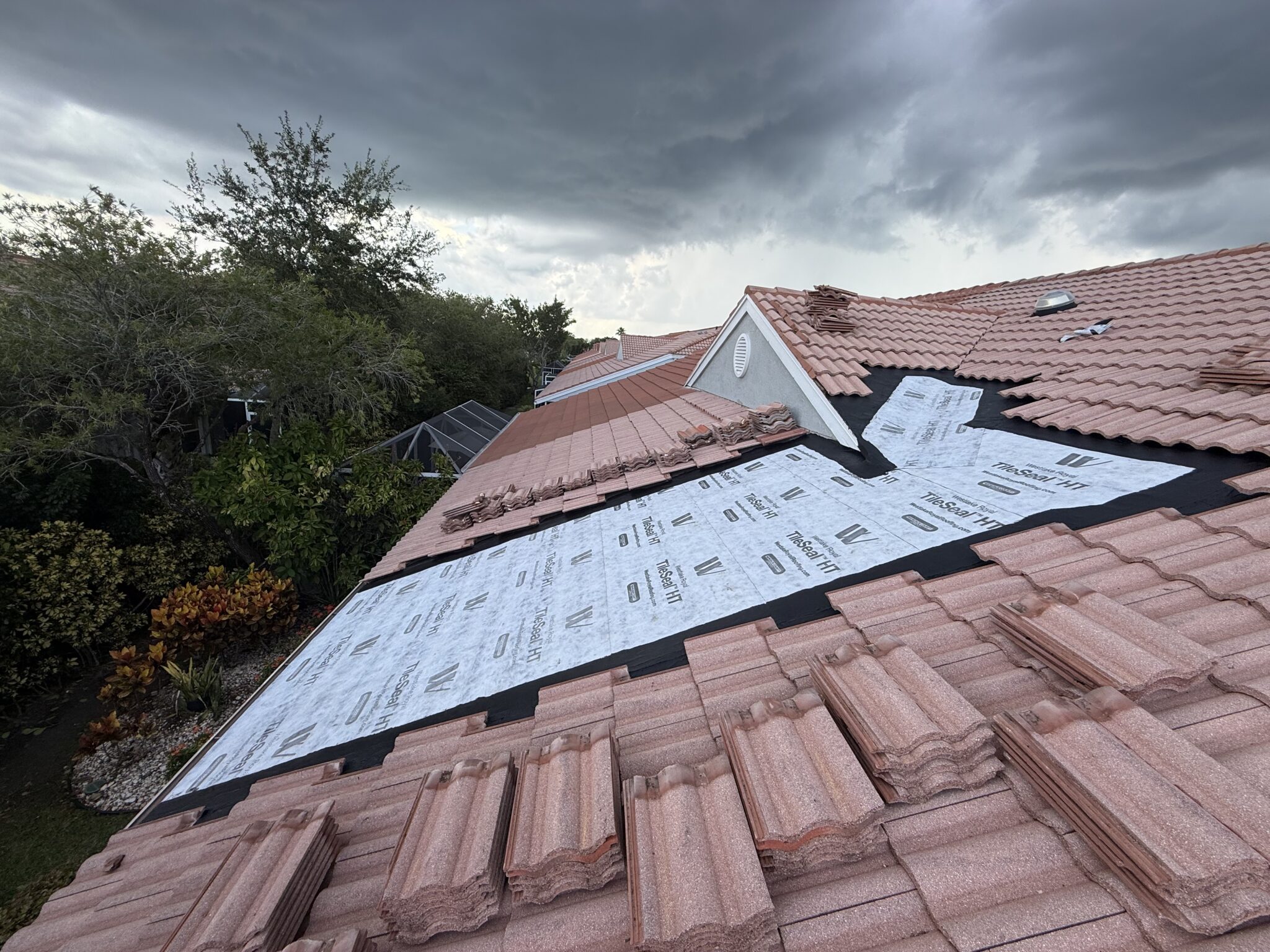 New self-adhered underlayment across a full tile roof repair section