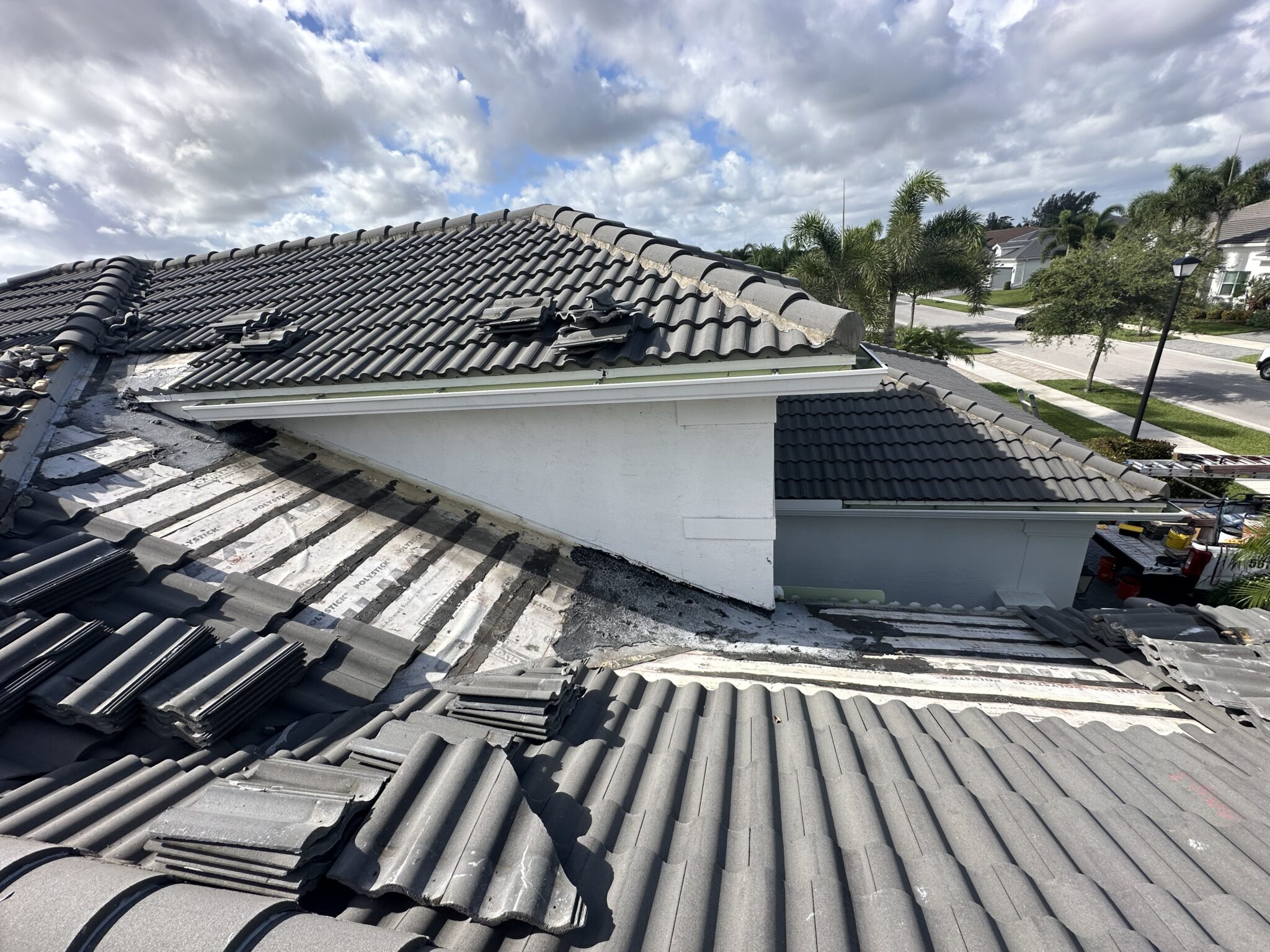 Palm Beach tile roof valley with a partial previous repair leaving surrounding section compromised