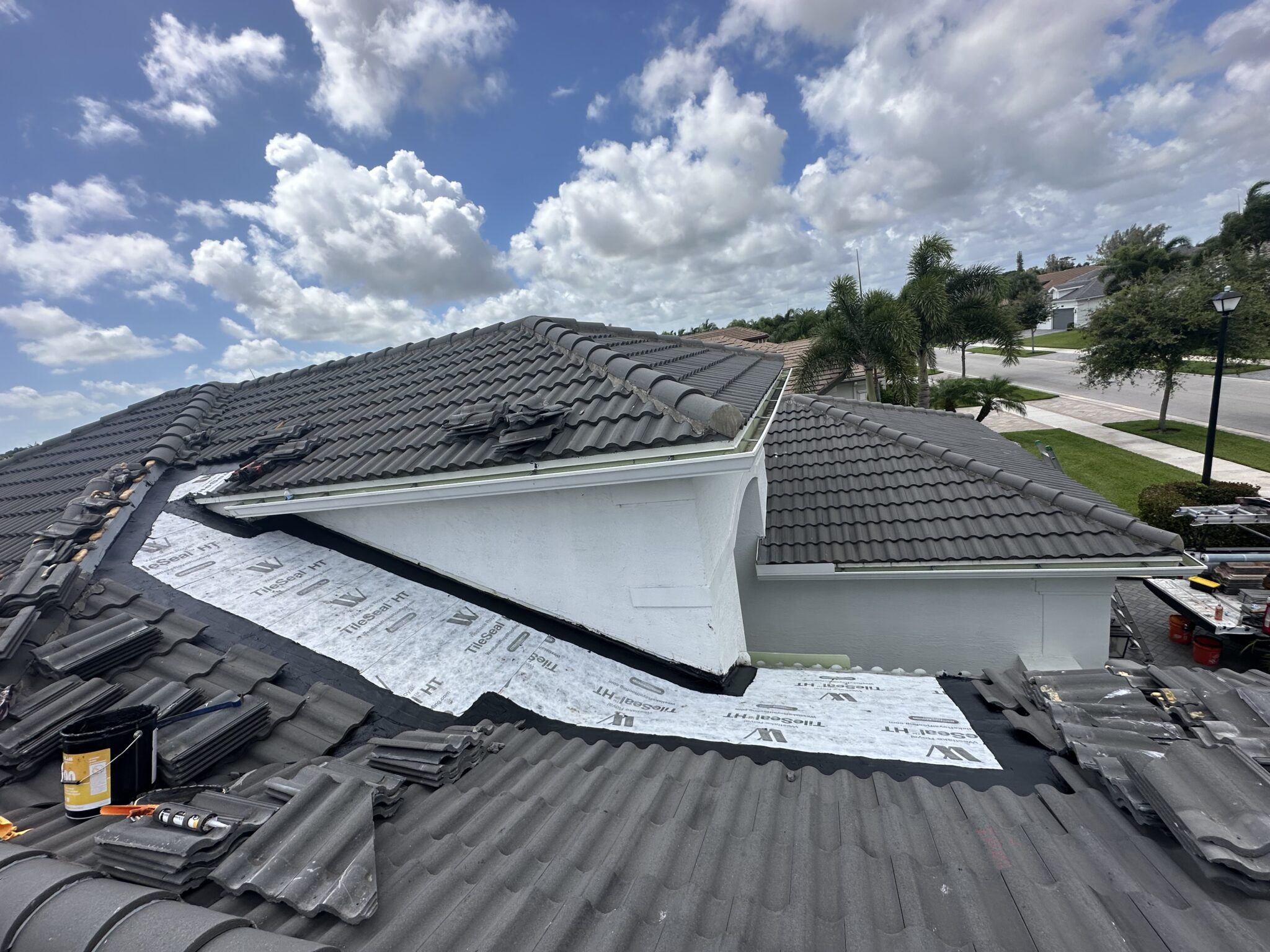Palm Beach tile roof valley rebuilt with continuous new high-temperature self-adhered underlayment up both slopes