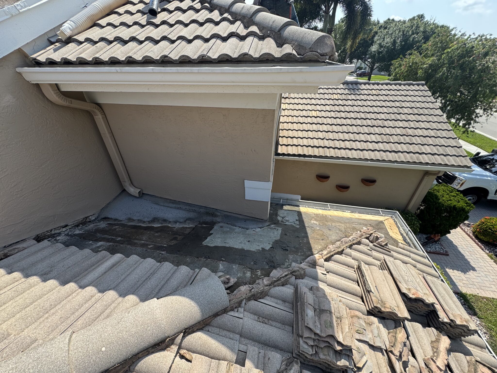 Delray Beach tile roof section opened up showing deteriorated waterproofing below a leaking roof vent