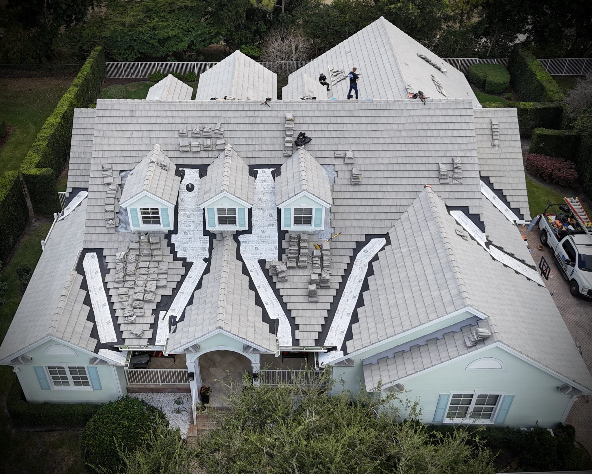 Drone view of a tile roof with repair sections under way