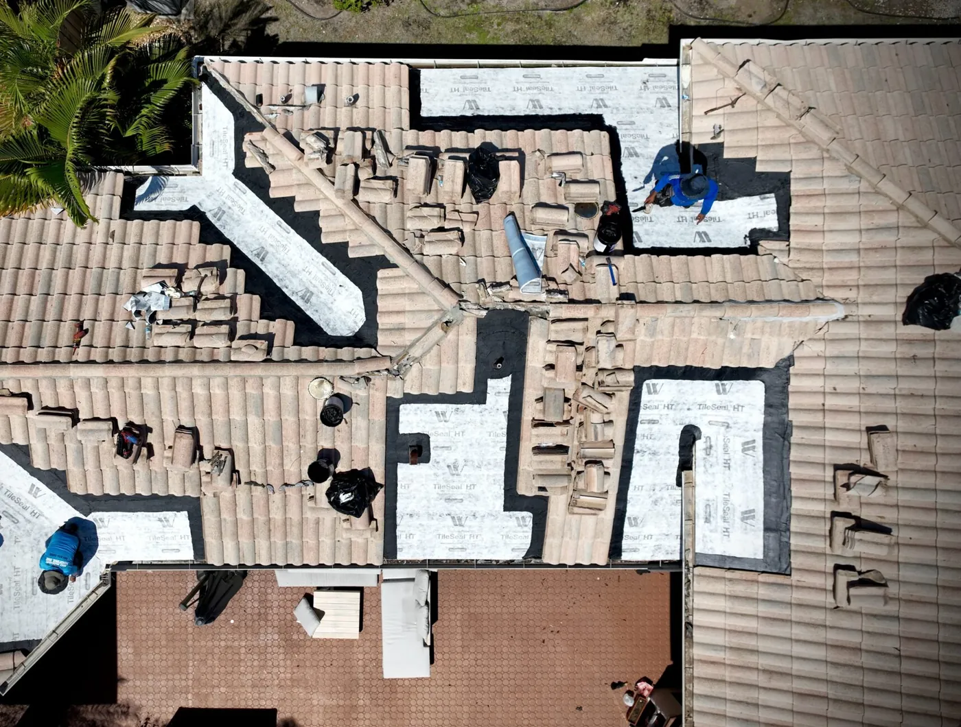 Tile removed on a Palm Beach County roof, exposing the underlayment and deck around the repair area