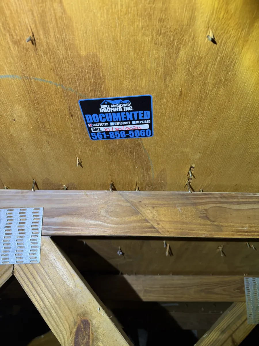 MMR Documented tag on plywood roof decking above attic truss with metal truss plate.