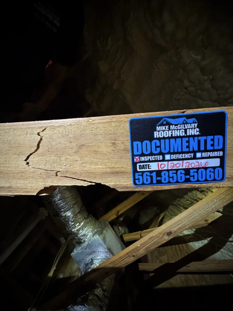 Split wood framing member in attic with MMR Documented tag and date.