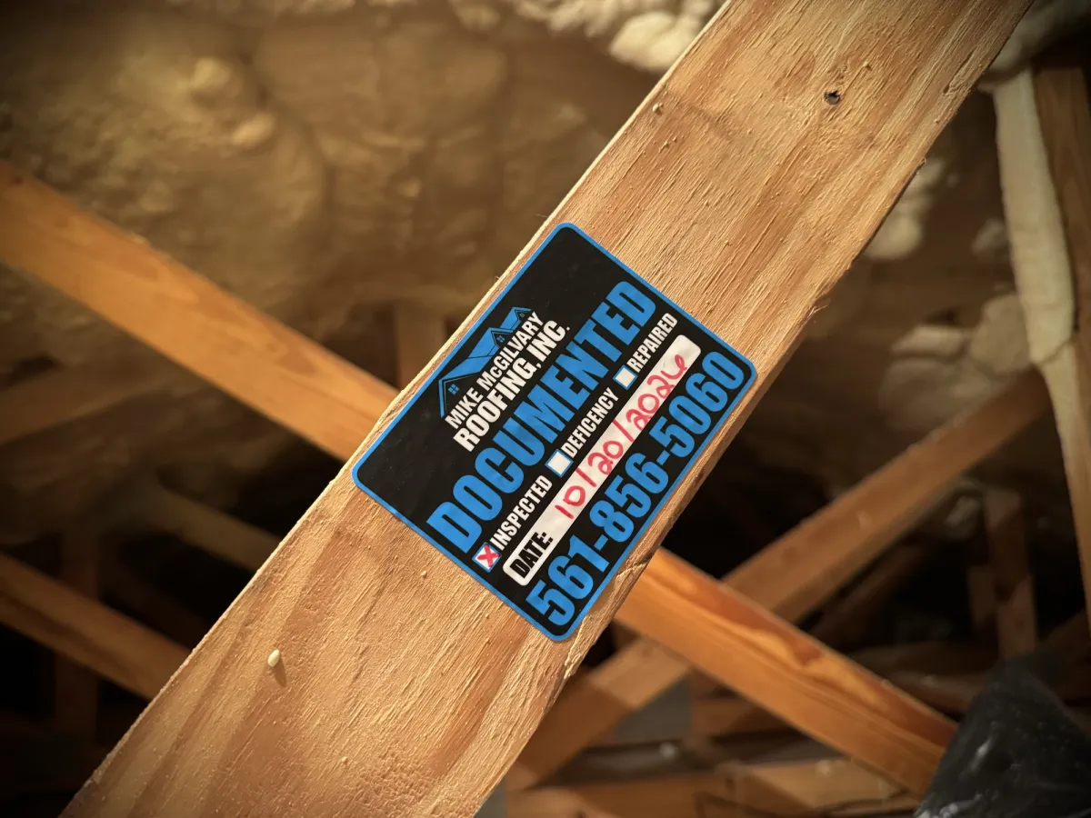 MMR Documented tag on an angled attic truss member with spray foam insulation in the background.