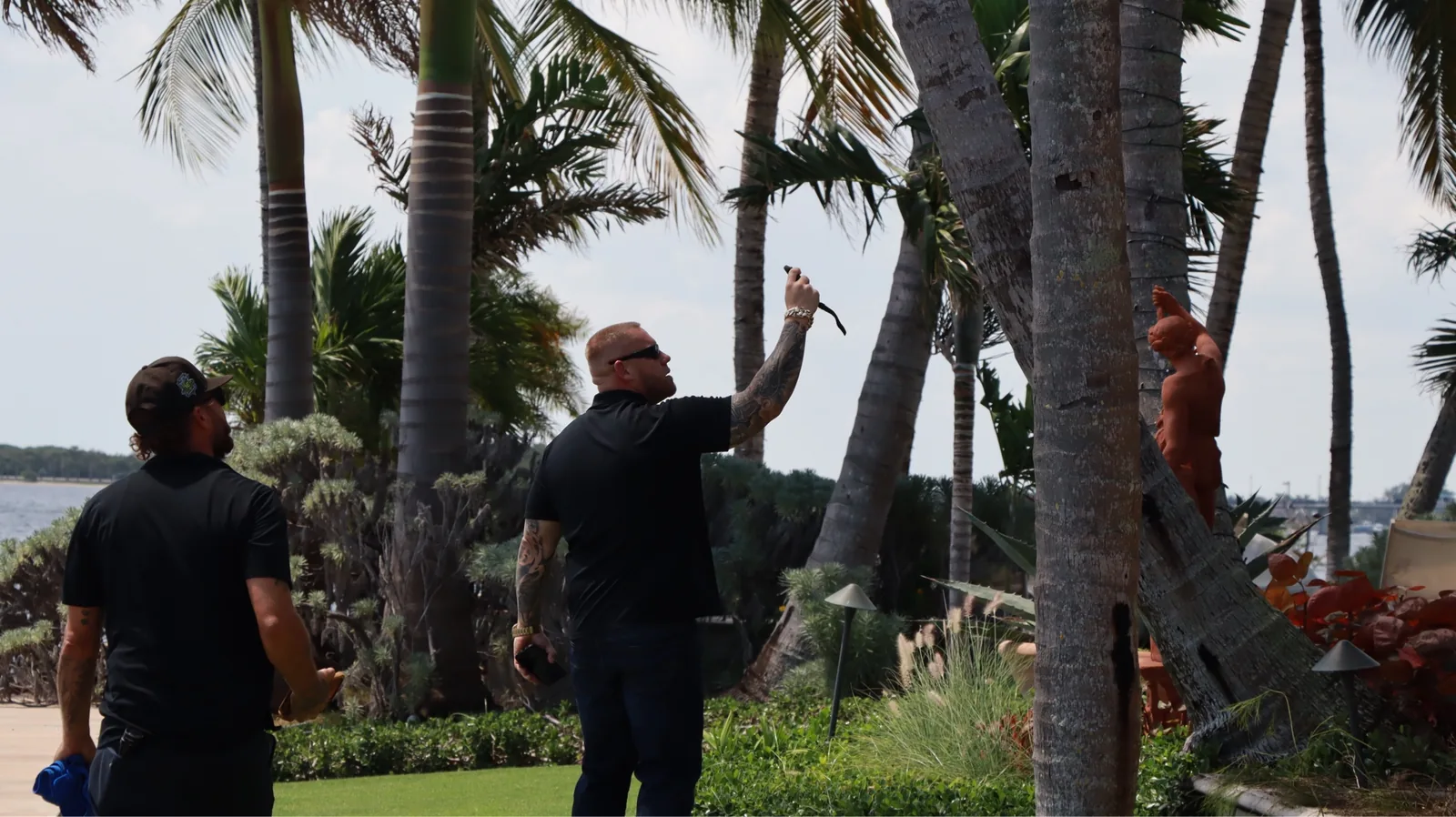 Mike McGilvary pointing out roof conditions during an exterior walkaround inspection at a Palm Beach County property