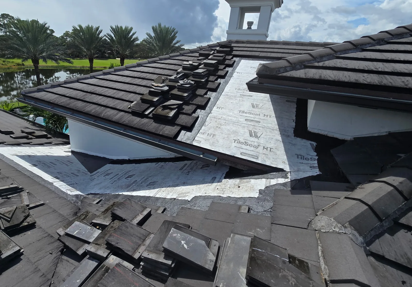 New high-temperature self-adhered underlayment installed across the rebuilt roof section on a North Palm Beach tile roof