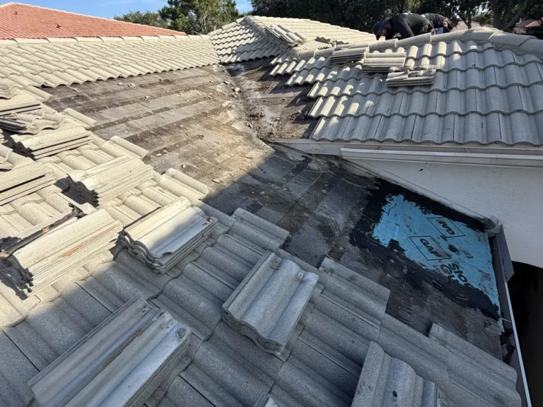 The long valley opened up, with the blue patch from the earlier repair and stained underlayment around it.
