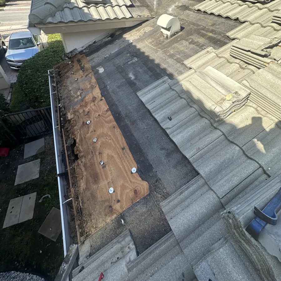Stage 1: the roof section along the gutter opened up, with rotted, water-damaged plywood exposed.