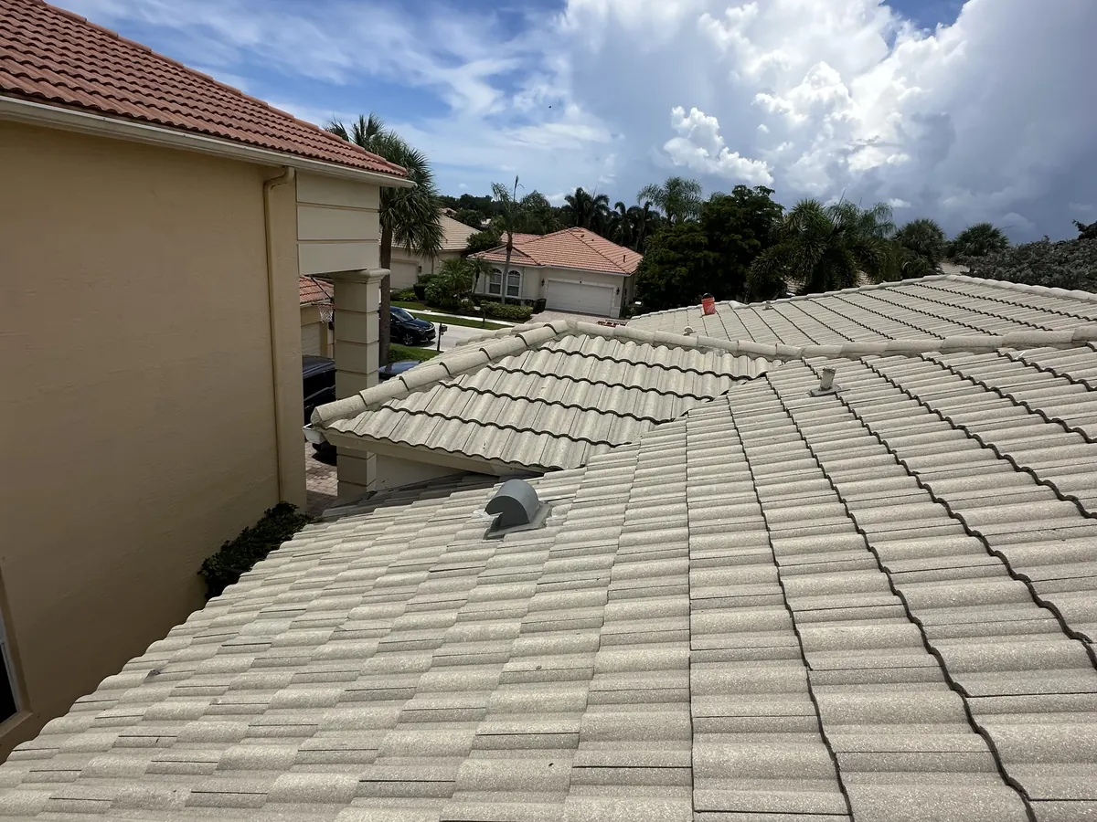 The repaired roof section with the existing concrete tiles reinstalled, matching the rest of the roof.
