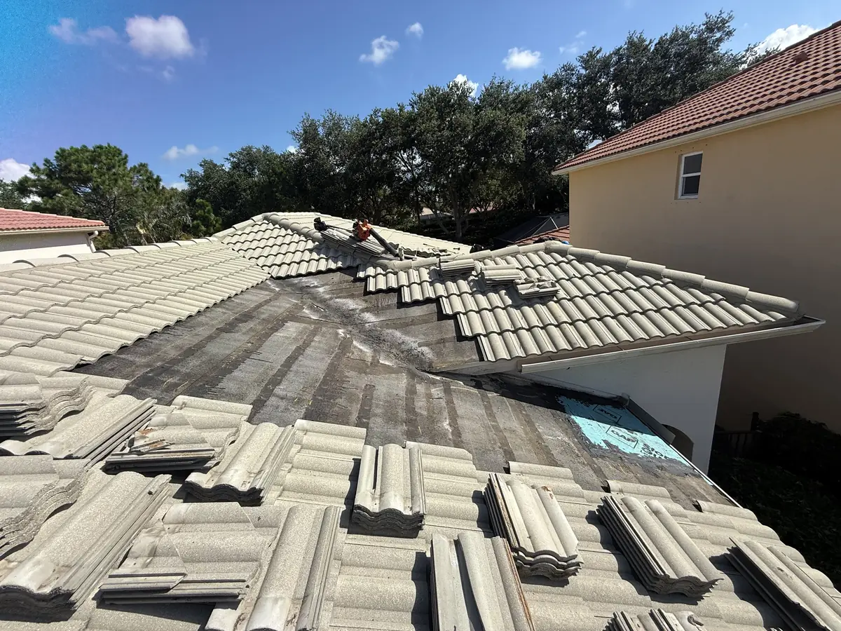 The primary roof valley before repair, with a blue patch from an earlier repair at its lower end.