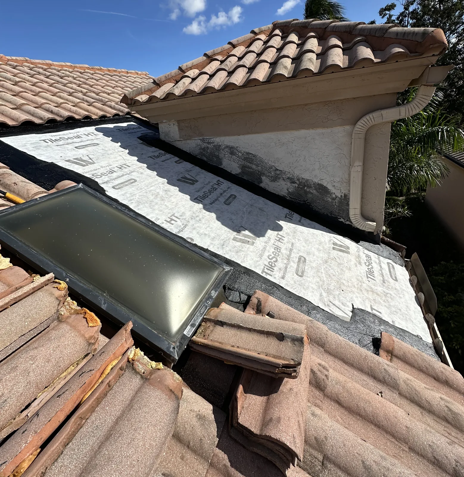 Rebuilt roof section around a skylight on a Palm Beach Shores tile roof with new self-adhered underlayment installed