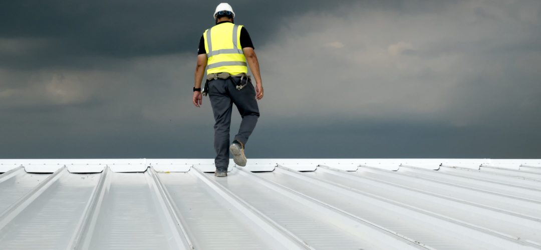 Construction engineer wear safety uniform inspection metal roofing work for roof industrial concept with copy space