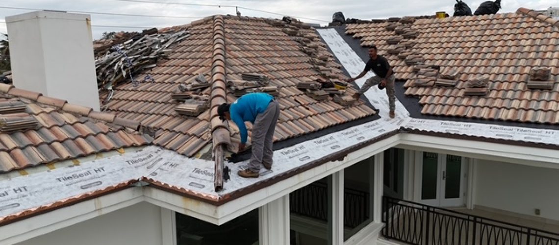 The Mike McGilvary Roofing crew working on a tile roof