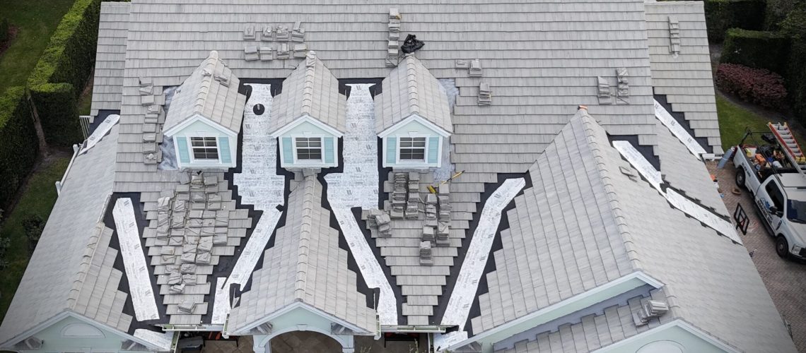 Drone view of a tile roof with repair sections under way