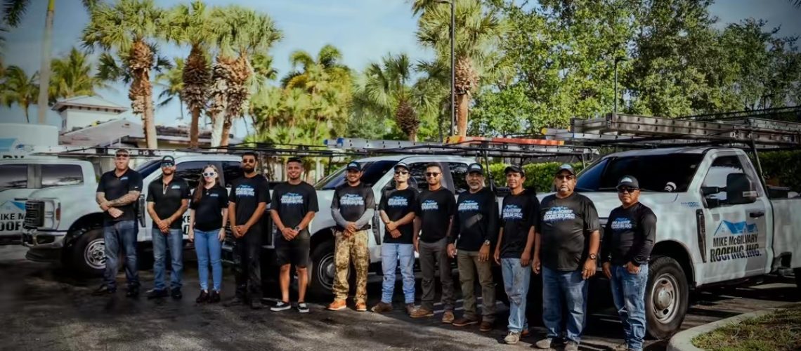 The Mike McGilvary Roofing crew in front of the company fleet