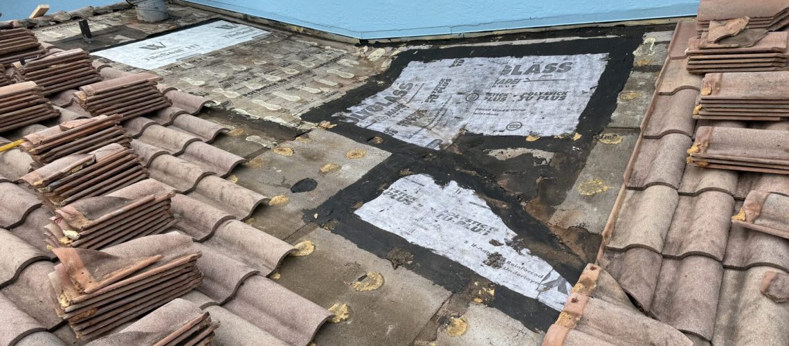 Several tile roof sections opened for new underlayment
