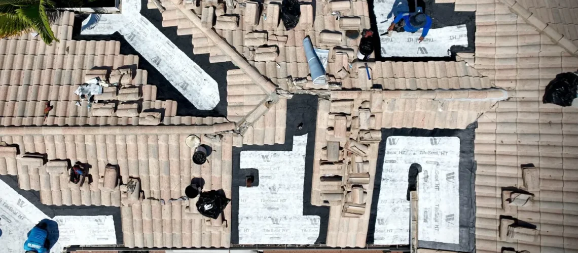 Drone view of tile roof sections opened for new underlayment