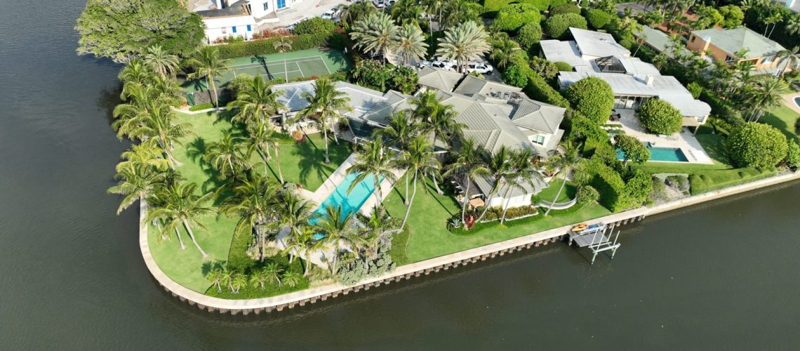 Aerial view of a Palm Beach County waterfront estate with a tile roof — the kind of roof evaluated for condition and remaining useful life under Florida Statute 627.7011